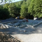 Das Umfeld des Schutzbaus wurde angeglichen und auch Raum für Präsentationsmöglichkeiten außerhalb des Gebäudes geschaffen (Foto: LWL-Archäologie für Westfalen/M. Zeiler). (vergrößerte Bildansicht wird geöffnet)